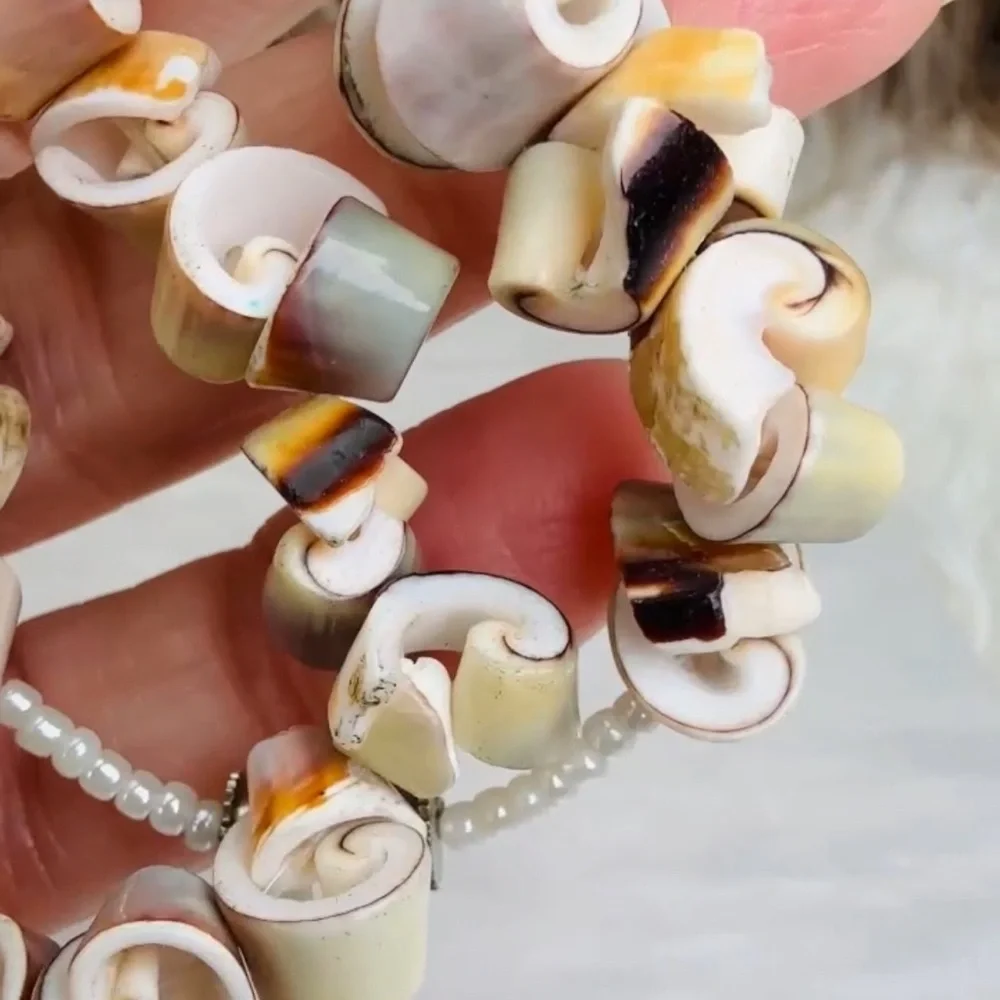 Beautiful vintage necklace composed of curly-cut conch shell beads individually